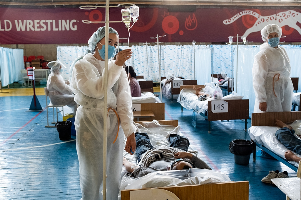 Doctors with patient beds