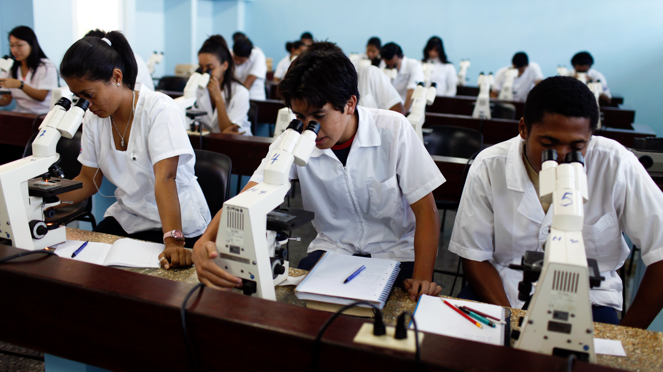 Doctors staring into microscopes